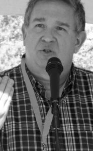 sean buvala speaking outside in a graysacle photo