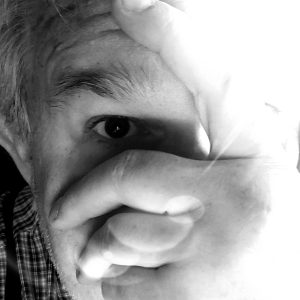 Sean Buvala covers his face with his hand in this symbolic picture of author rejection. Get some coaching with Sean at authoryes.com